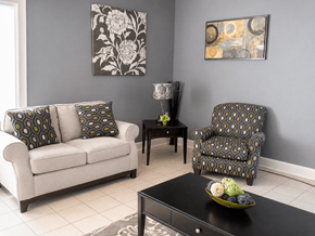 Walls apartment for rent - A living room with a couch, chair, and table.