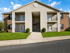Walls apartment for rent - A two-story apartment building with a front lawn and a driveway.