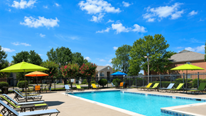 Walls apartment for rent - A pool area with sun loungers and umbrellas.