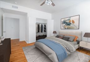 Boerne apartment for rent - A bedroom with a bed, nightstand, and a painting on the wall.