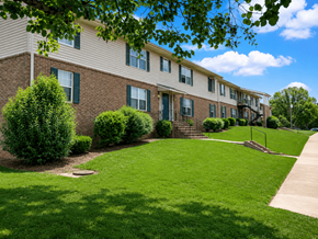 Forsyth apartment for rent - Apartment building with green bushes in front.