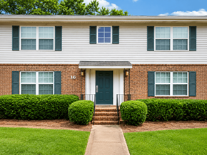 Forsyth apartment for rent - A house with a green door and two windows with green shutters.