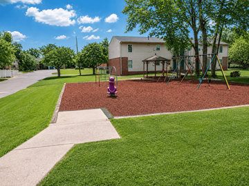 Forsyth apartment for rent - A playground with a red surface and a purple slide.