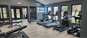 St Peters apartment for rent - A gym with a variety of equipment including treadmills, weights, and exercise machines. at Vanderbilt Apartments, St Peters, MO, 63376