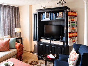 Rockford apartment for rent - A living room with a black entertainment center and a blue chair.