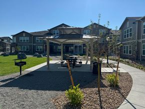 Denver apartment for rent - a park with a pavilion and picnic table in front of an apartment building