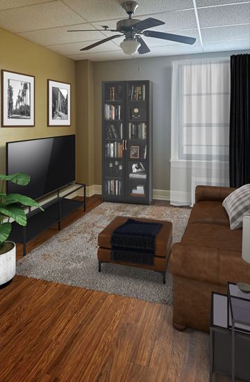 Little Rock apartment for rent - A living room with a brown couch, a television, and a bookshelf.