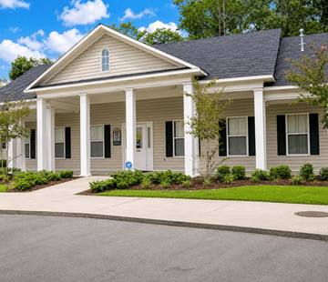 Waycross apartment for rent - A house with a front porch and a driveway.
