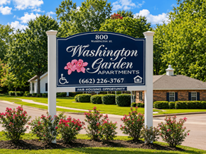 Grenada apartment for rent - A sign for Washington Garden Apartments stands in front of a building.