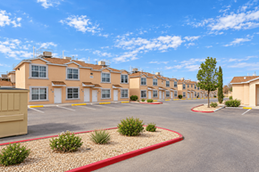 El Paso townhouse for rent - A large building with a parking lot in front of it.