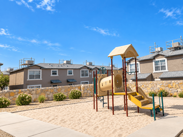 El Paso townhouse for rent - A playground with a yellow slide in front of a building.
