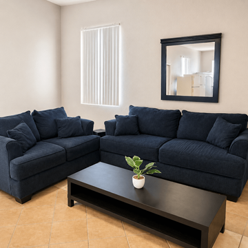 Horizon townhouse for rent - A living room with two blue couches and a coffee table.