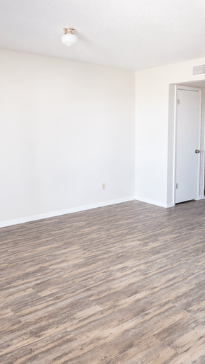 Horizon townhouse for rent - A room with a white door and a light brown floor.