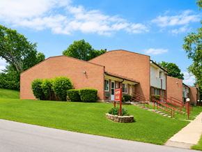 Loveland townhouse for rent - A red brick building with a red gate in front.