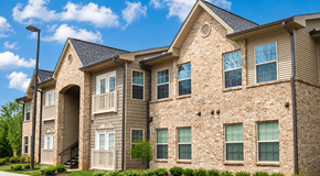 Cleveland apartment for rent - A large, multi-story residential building with a stone facade and multiple windows.