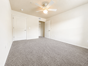 Cleveland apartment for rent - A room with a ceiling fan and carpeted floor.