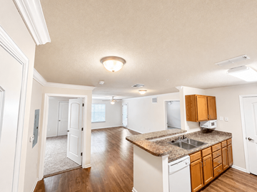 Cleveland apartment for rent - A kitchen with white cabinets and a granite countertop.