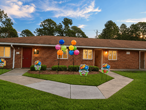 Gulfport apartment for rent - A house with a driveway and a sign that says "Welcome to Sunshine Elementary School".