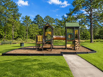 Gulfport apartment for rent - A playground with a slide and a wooden structure.