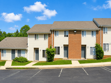 Staunton townhouse for rent - A row of townhouses with a parking lot in front.
