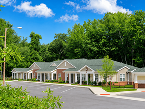 Lumberton apartment for rent - A row of houses with green roofs and white columns.