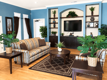 Lumberton apartment for rent - A living room with a striped couch, a coffee table, and a television.