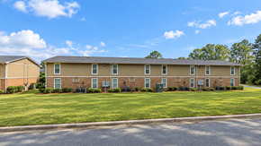 Thomasville apartment for rent - Apartment complex with a grassy front yard and a clear blue sky.