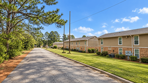 Thomasville apartment for rent - A long street with apartment buildings on both sides.