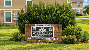 Thomasville apartment for rent - A sign for Wood Valley Apartments is in front of a building.