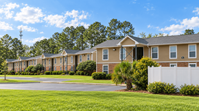 Thomasville apartment for rent - A row of houses with a white fence in front.