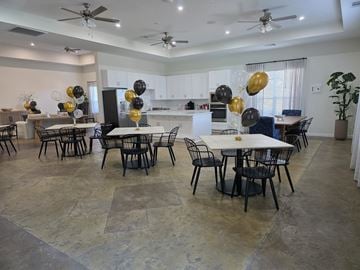 Conroe apartment for rent - A dining room with a table surrounded by chairs and balloons.