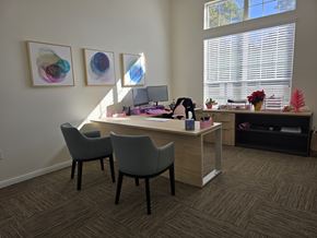 Conroe apartment for rent - A room with a desk and chairs with a painting on the wall.