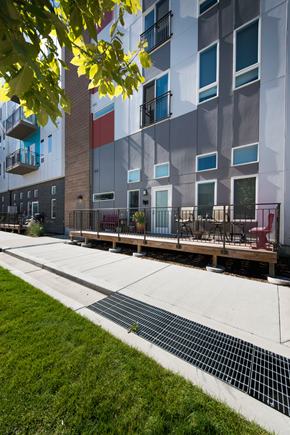 Denver apartment for rent - an exterior view of an apartment building with a sidewalk and patio