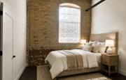 Prattville apartment for rent - A bedroom with a bed, nightstand, and a window with blinds.