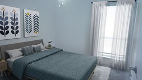 Houston townhouse for rent - A bedroom with a large bed and two wall art pieces.
