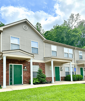 St. Louis townhouse for rent - the front of a gray house with green doors