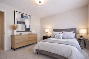 Springfield townhouse for rent - A bedroom with a large bed and a wooden dresser.