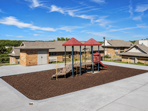 North Little Rock apartment for rent - A playground with a red roofed structure and a slide.