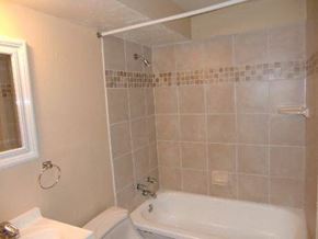 Lakewood apartment for rent - a bathroom with a tub and a toilet and a sink