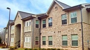 Cleveland apartment for rent - A large stone and siding house with a grey roof.