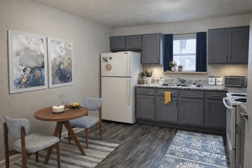 Oklahoma City apartment for rent - A kitchen with a refrigerator, table, and chairs.