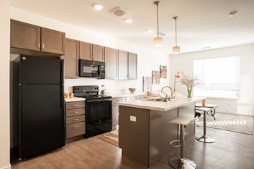 Denver apartment for rent - A modern kitchen with dark brown cabinets and appliances.