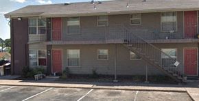 Austin townhouse for rent - Apartment building with a red door and a staircase.