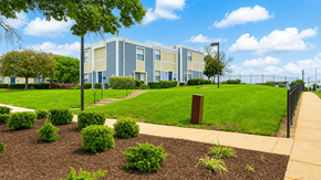 Capitol Heights townhouse for rent - A modern building with a green lawn in front.
