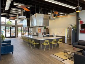 Denver apartment for rent - A modern kitchen with a long island and yellow chairs.