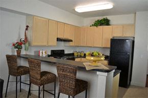 Denver apartment for rent - a kitchen with a counter with three chairs