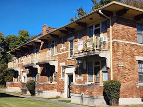 Memphis apartment for rent - A red brick building with a balcony on the second floor.