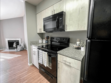 St. Louis apartment for rent - a kitchen with a black stove and a microwave