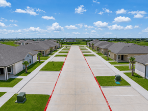 Rockport apartment for rent - A long row of houses with a red line down the middle of the driveway.