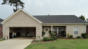 Columbus apartment for rent - a brick house with a driveway and a garage door open